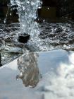 Reflecting On A Garden Fountain